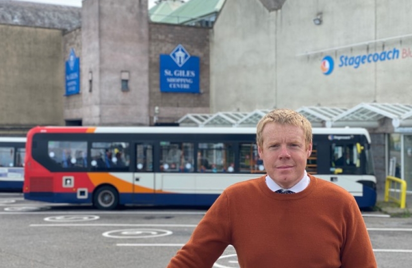 Tim Eagle standing infront of a bus