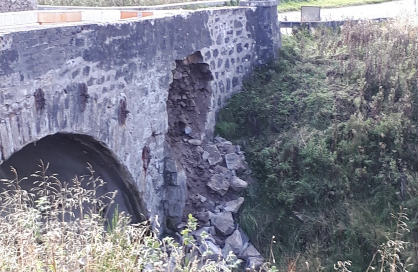 photo of rocks falling from bridge