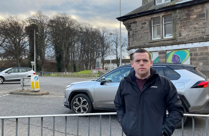 Douglas stands infront of the problematic roundabout junction as a car passes