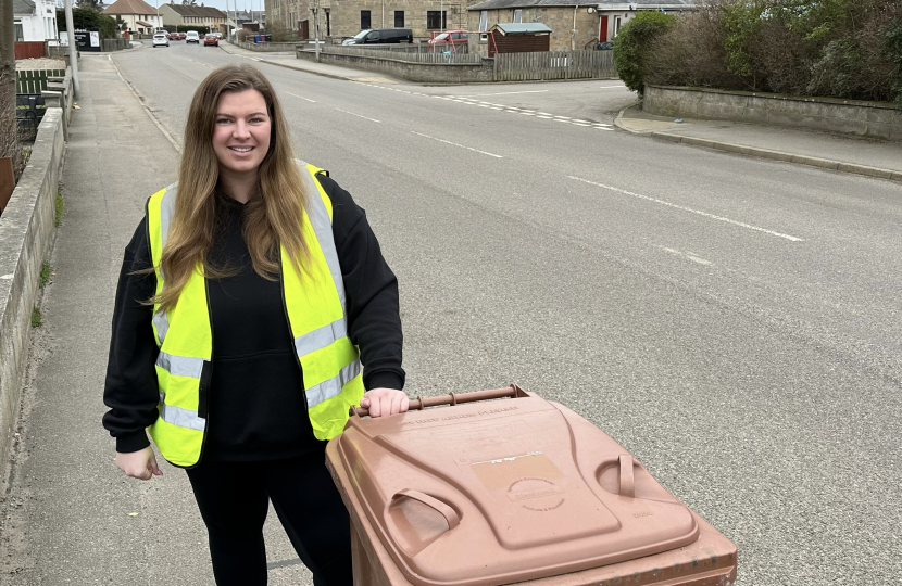 Amber stands with Brown Bin in Bishopmill