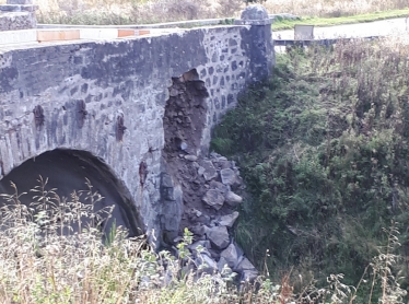 photo of rocks falling from bridge