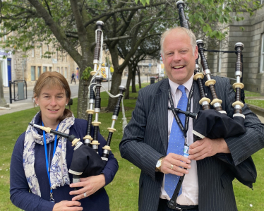 Kathleen and Neil pose with bagpipes