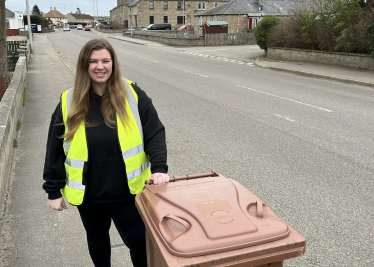 Amber stands with Brown Bin in Bishopmill